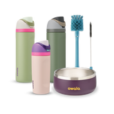 Family Bundle with accessories; two tall FreeSip water bottles in green and pink-mauve, a Kids Tumbler in pink-mauve with teal lid, a purple Pet Bowl with stainless rim, and a blue bottle brush